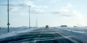 Honda minivan on the highway during a snowy conditions.