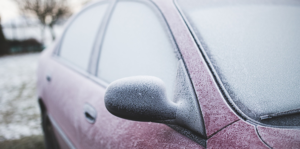 Windshield of a Ford vehicle covered with morning frost in winter.