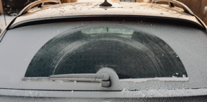 Rear windshield of BMW covered in frost and snow